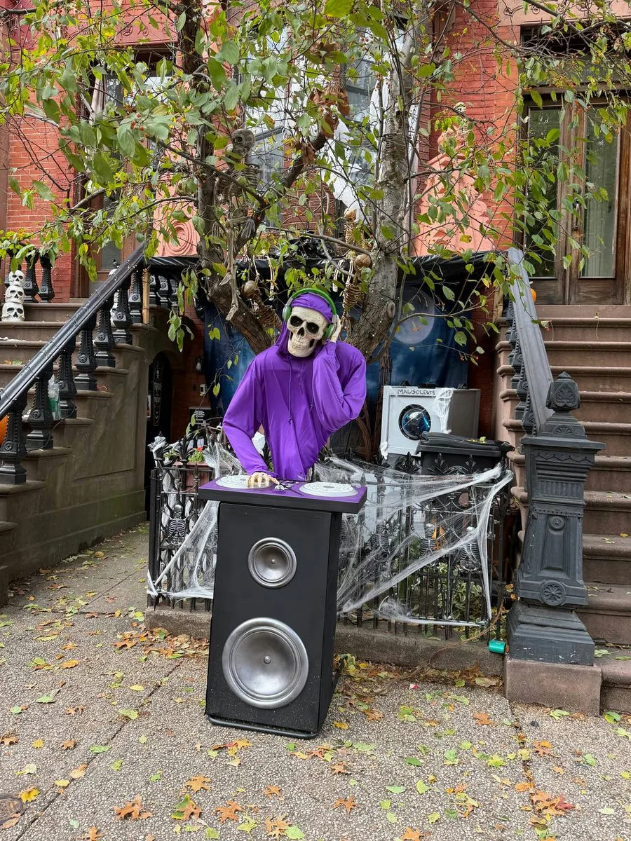 Skeleton DJ booth decoration on a Park Slope stoop